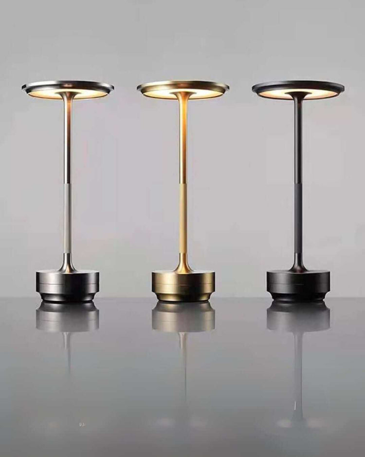 Three LumiHikari Base Lamps in brushed metal finishes showcasing cool, warm, and mixed ambient lighting modes on a reflective surface
