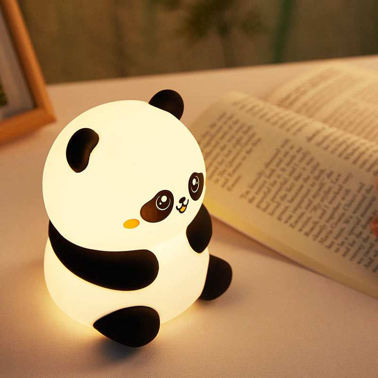 Cute panda night light glowing softly beside an open book, perfect kids LED lamp gift